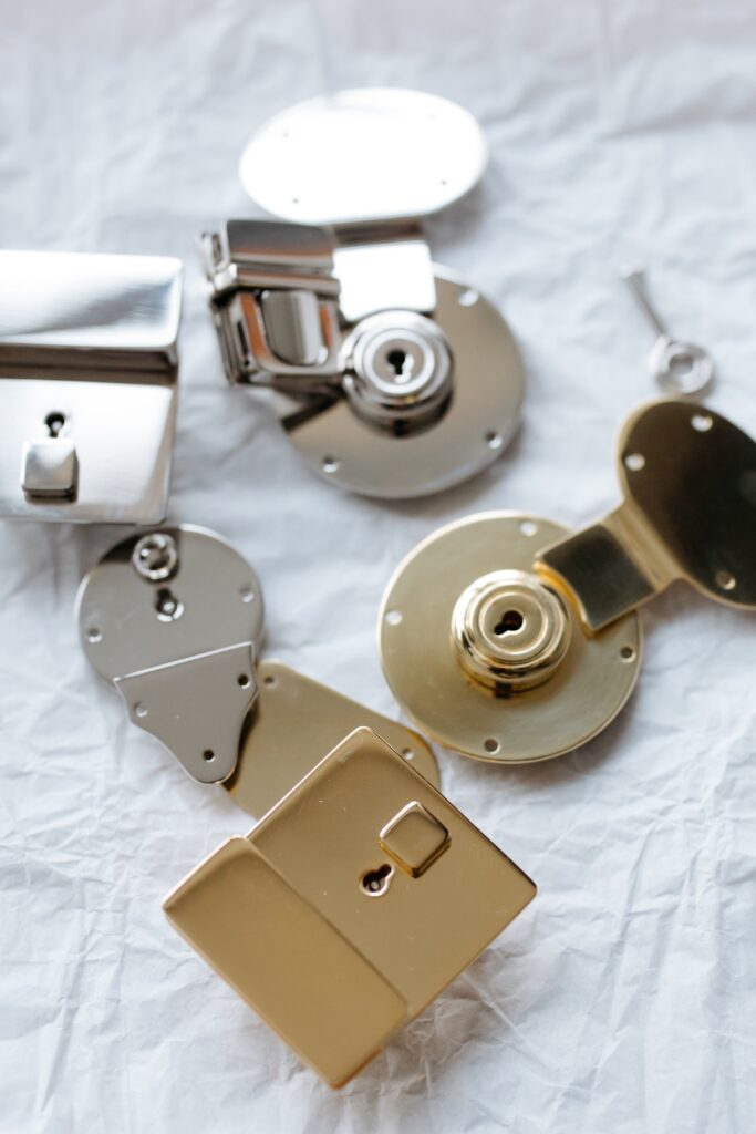 An array of various lock hardware components in metallic finishes on a wrinkled white background, highlighting solutions for lock-related issues.